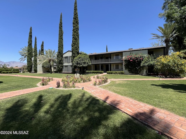 view of front of home with a mountain view and a front yard