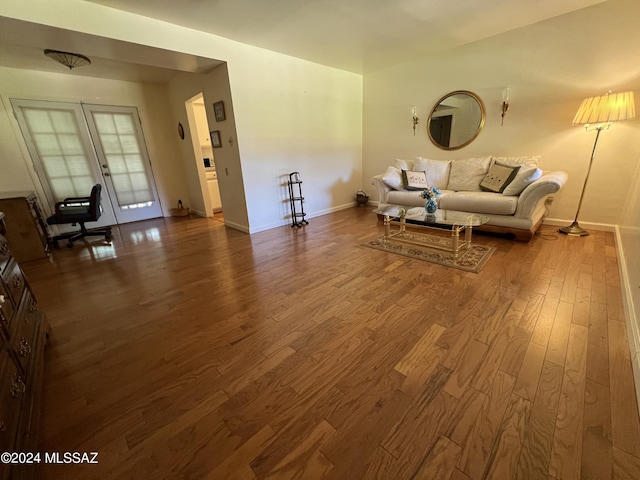 unfurnished living room featuring french doors and hardwood / wood-style floors