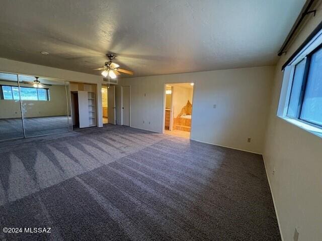 interior space with carpet, plenty of natural light, and ceiling fan