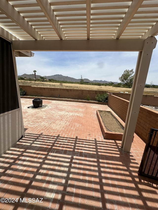 view of patio / terrace featuring a fire pit, a mountain view, and a pergola