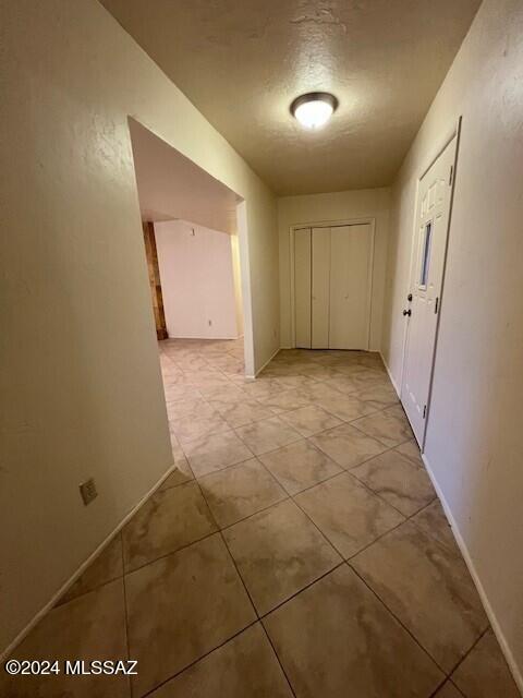 hall with a textured ceiling