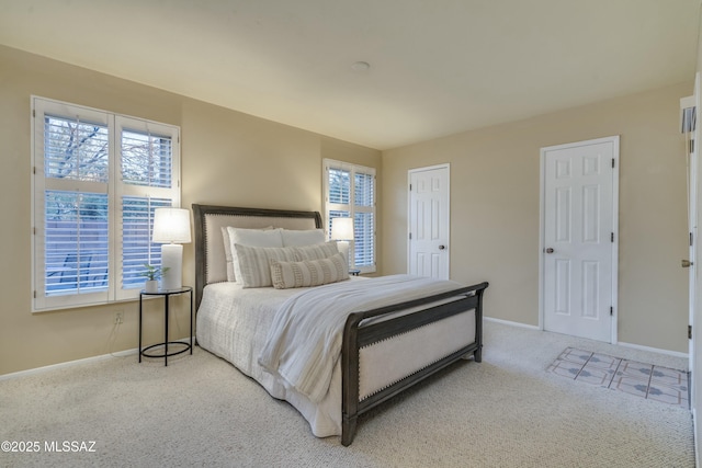 bedroom with light colored carpet and multiple windows