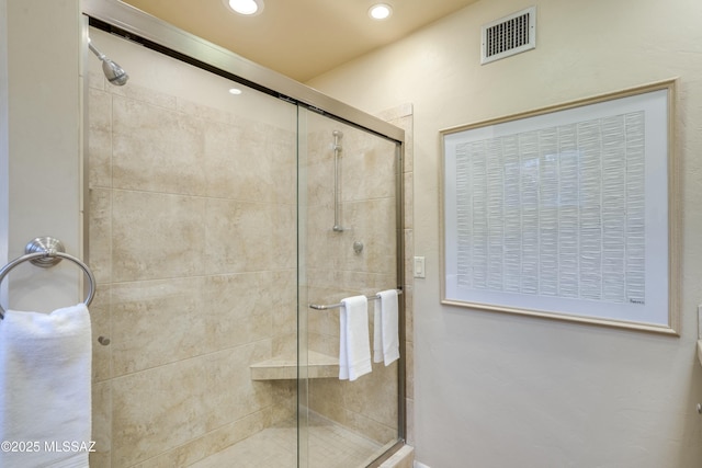 bathroom featuring a shower with shower door