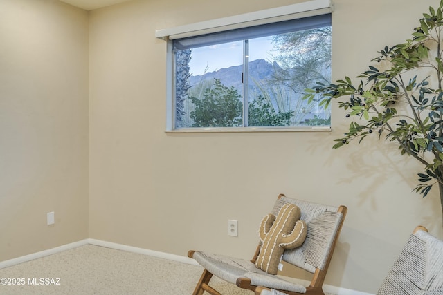 living area featuring carpet and a mountain view