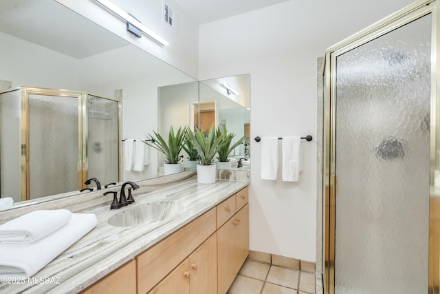 bathroom featuring vanity, tile patterned flooring, and a shower with door