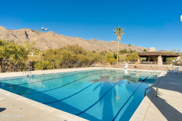 view of swimming pool with a mountain view