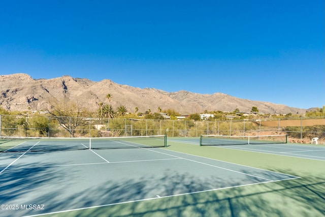 view of tennis court featuring a mountain view and basketball court