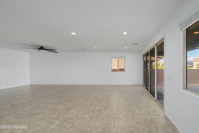 tiled spare room featuring ceiling fan