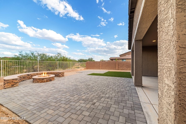 view of patio / terrace with an outdoor fire pit