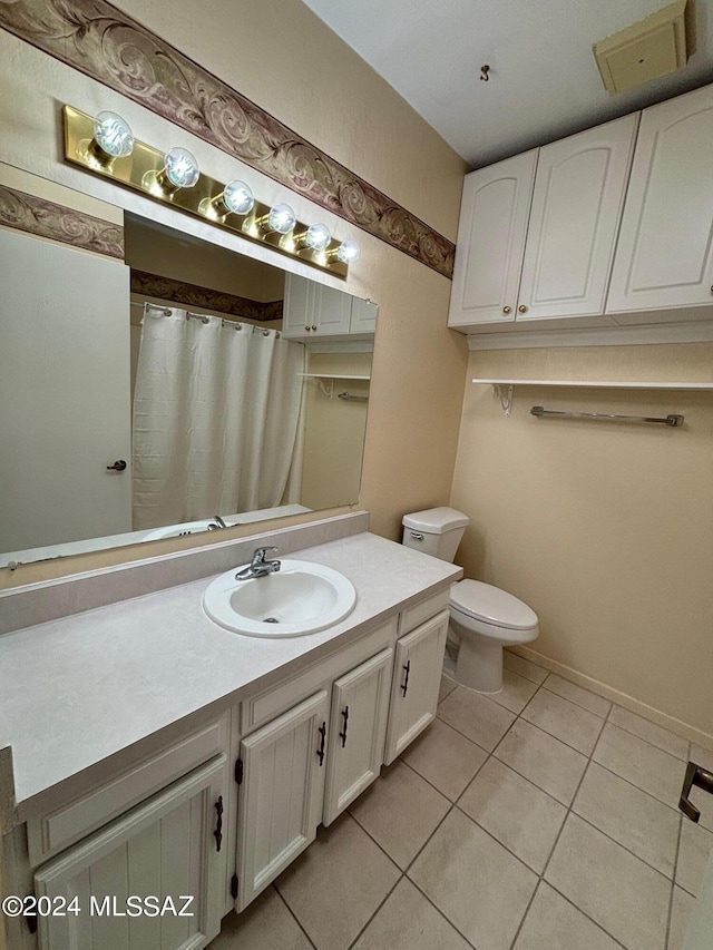 bathroom with tile patterned floors, vanity, and toilet