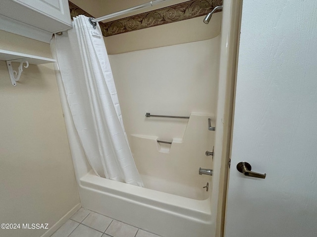 bathroom with tile patterned flooring and shower / bathtub combination with curtain