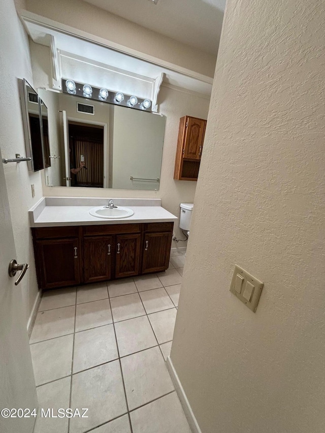 bathroom with tile patterned floors, vanity, and toilet