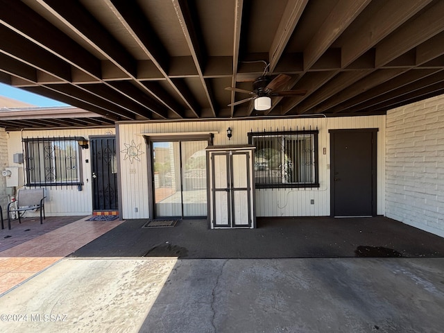 doorway to property with ceiling fan and a patio