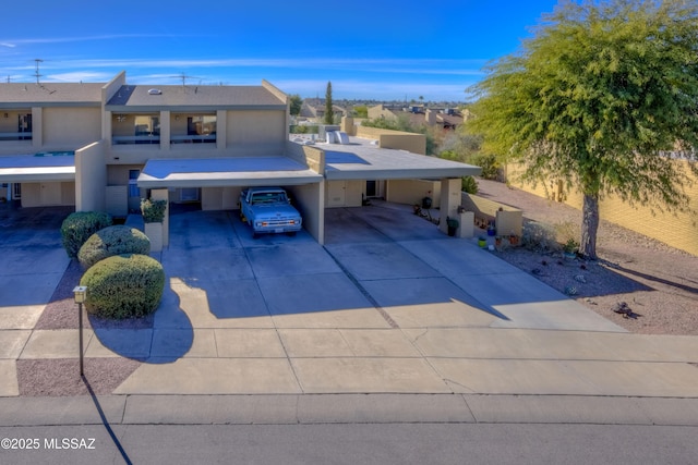 view of front of property featuring a carport