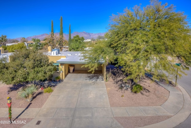 view of front of property with a mountain view and a carport