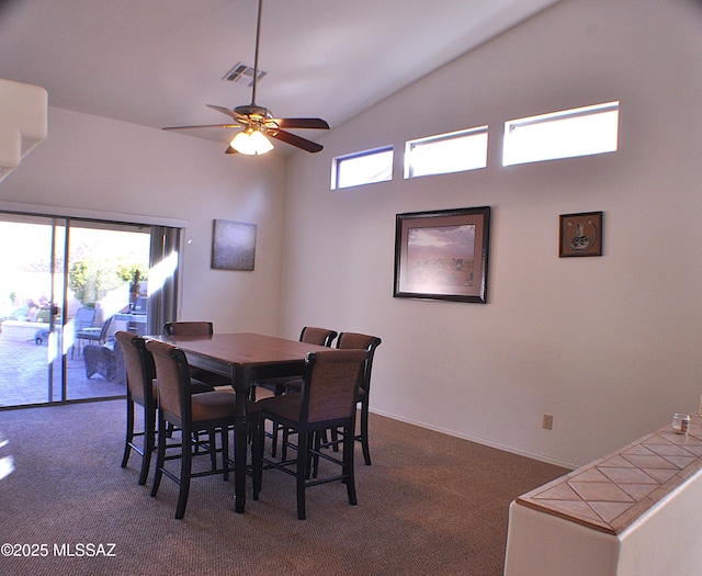 dining area with dark colored carpet, vaulted ceiling, and ceiling fan