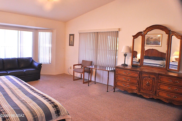 bedroom with light carpet and lofted ceiling