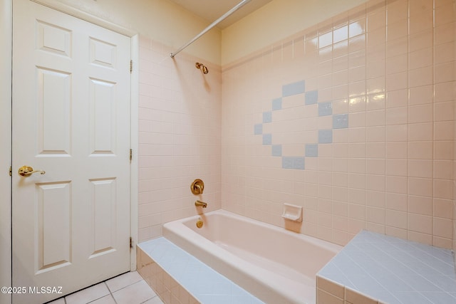 bathroom featuring tile patterned floors and tiled shower / bath combo