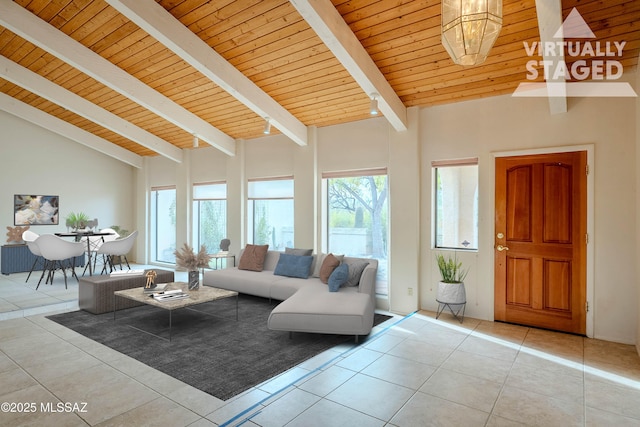 living room with beamed ceiling, plenty of natural light, light tile patterned floors, and wood ceiling