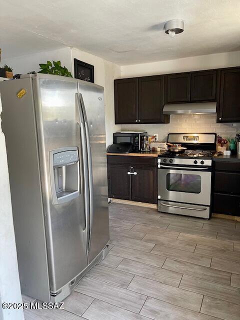 kitchen with backsplash, dark brown cabinetry, and stainless steel appliances