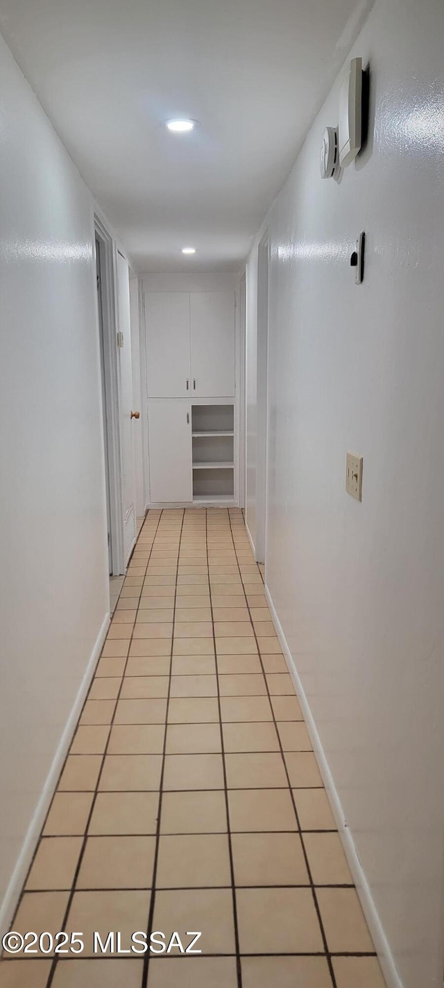 corridor with light tile patterned flooring