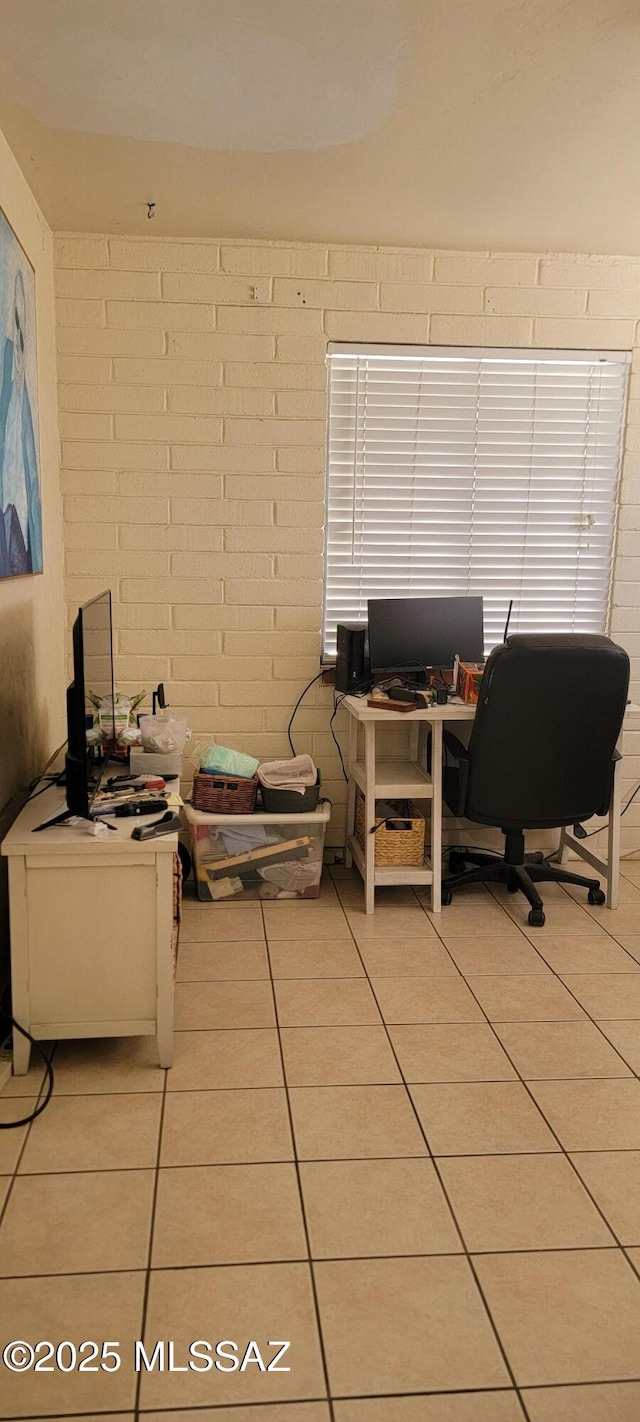 tiled home office with brick wall