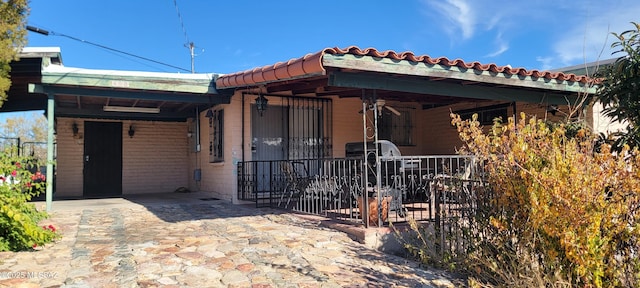 view of front of home featuring covered porch and a carport