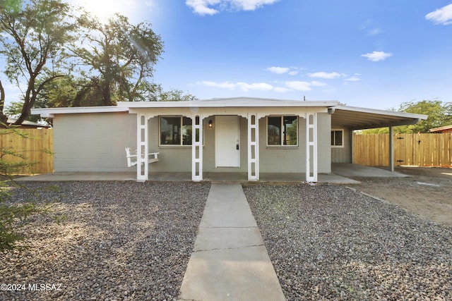 ranch-style house with a carport and a porch