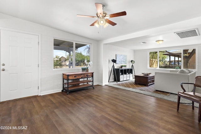 living room with dark hardwood / wood-style floors, ceiling fan, and vaulted ceiling