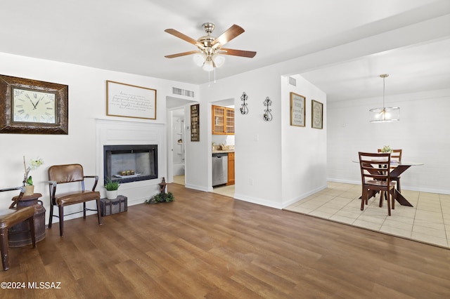 living room featuring hardwood / wood-style floors and ceiling fan