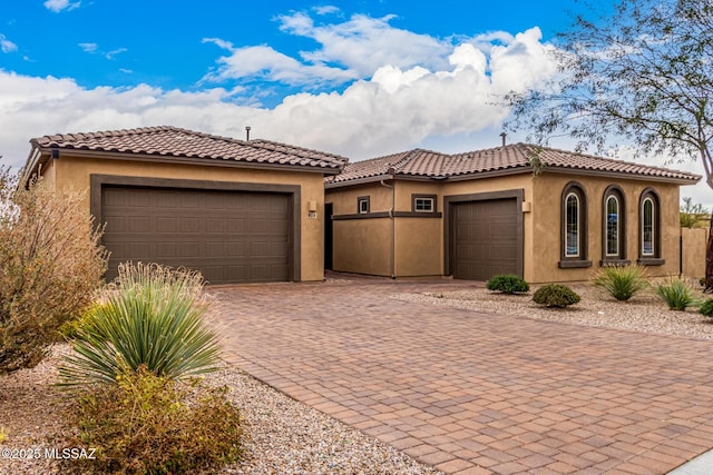 mediterranean / spanish-style home featuring a garage