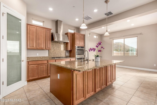 kitchen featuring stainless steel appliances, visible vents, light tile patterned flooring, and wall chimney exhaust hood