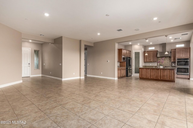 unfurnished living room with light tile patterned floors, baseboards, recessed lighting, and visible vents