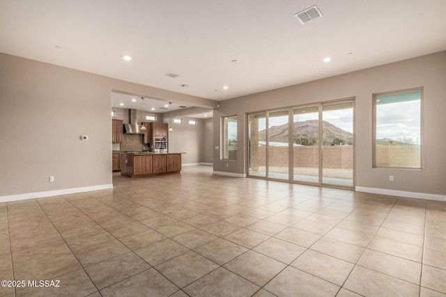 unfurnished living room featuring light tile patterned flooring, baseboards, recessed lighting, and visible vents