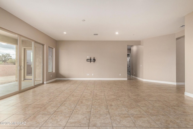 spare room featuring recessed lighting, baseboards, light tile patterned floors, and visible vents