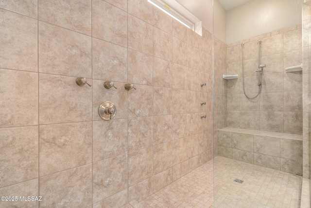 bathroom with tiled shower