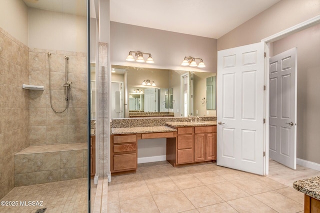 full bath featuring a walk in shower, baseboards, vanity, and tile patterned floors