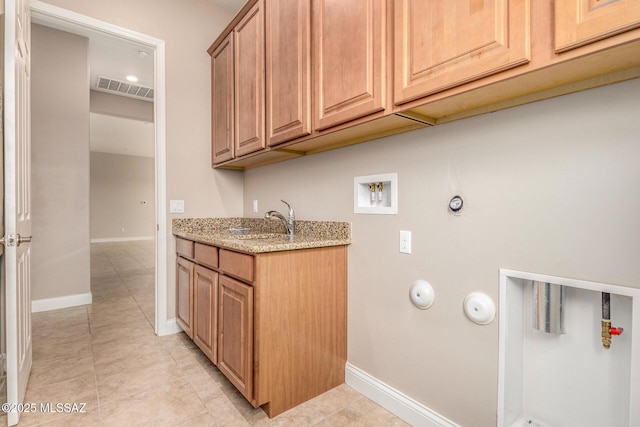 laundry room featuring light tile patterned floors, baseboards, hookup for a washing machine, and visible vents
