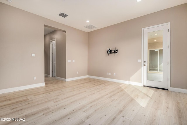 unfurnished room with recessed lighting, visible vents, and light wood-style flooring