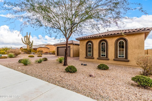 mediterranean / spanish-style home with a garage