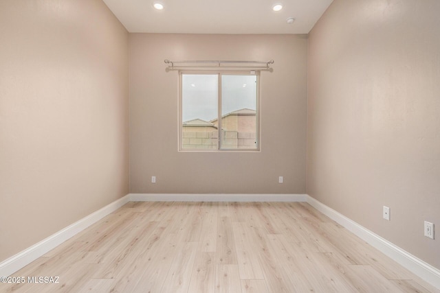 spare room with recessed lighting, baseboards, and light wood-style flooring