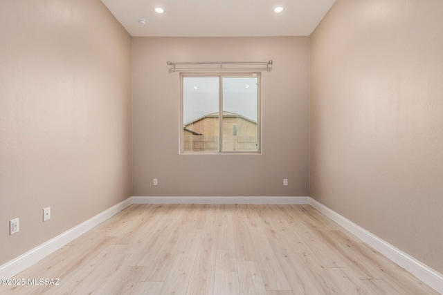 unfurnished room with recessed lighting, baseboards, and wood finished floors