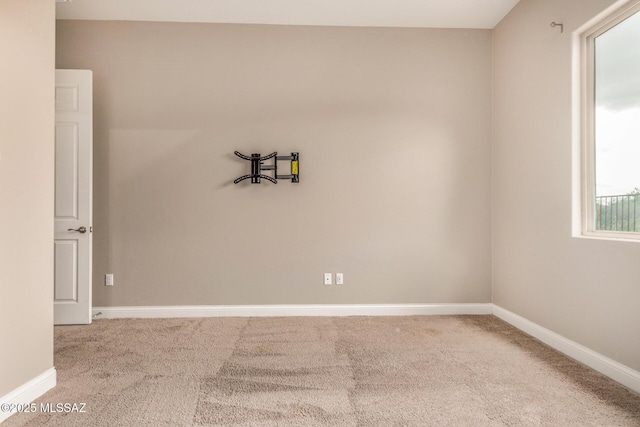 carpeted empty room with baseboards