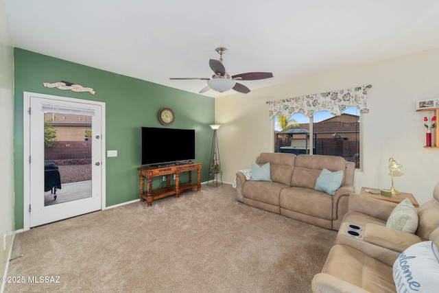 carpeted living room with ceiling fan