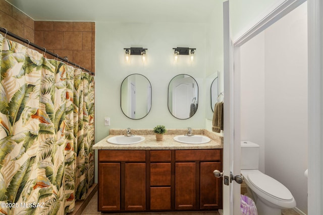 bathroom with vanity, toilet, and walk in shower