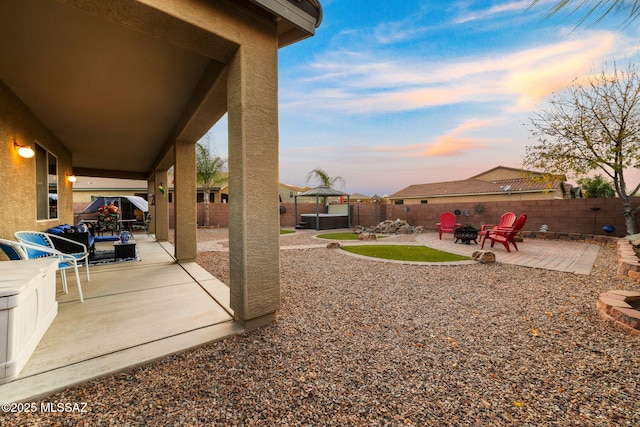 yard at dusk with a patio area