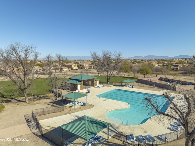 view of swimming pool with a mountain view and a patio area