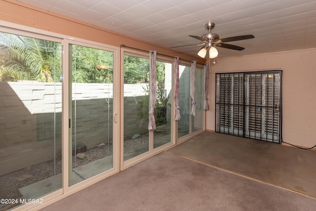 unfurnished sunroom with ceiling fan