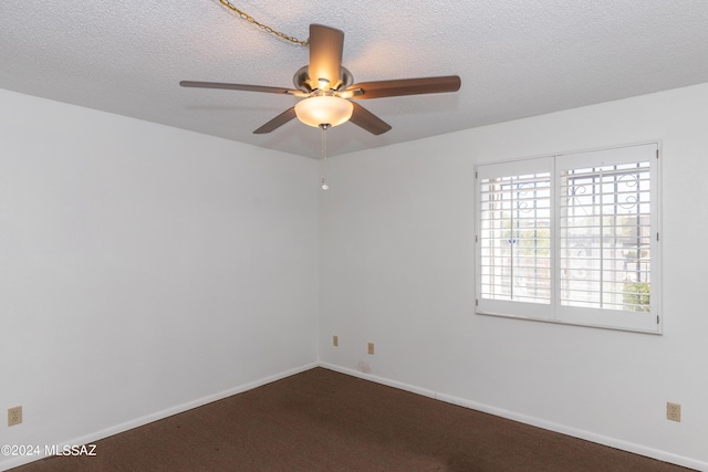 carpeted empty room featuring ceiling fan and a textured ceiling