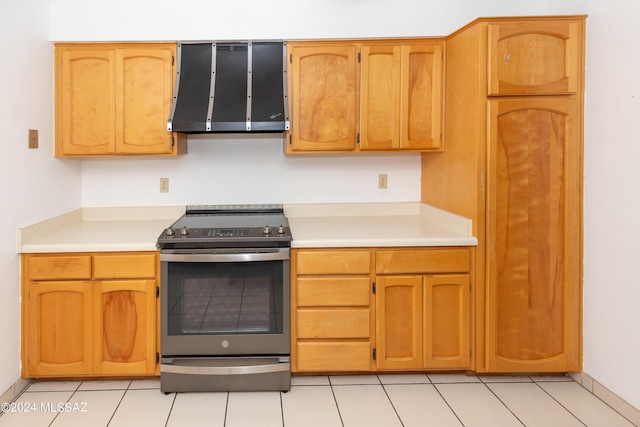 kitchen featuring extractor fan, stainless steel electric range oven, and light tile patterned flooring